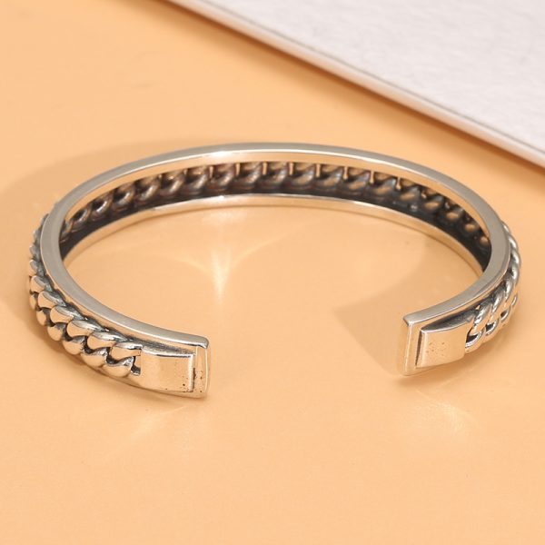 sterling silver bangle bracelet, the surface of the bracelet is engraved in the shape of a Cuban link.