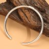 Sterling silver bangle bracelet, oval solid silver centerpiece engraved with a lotus flower