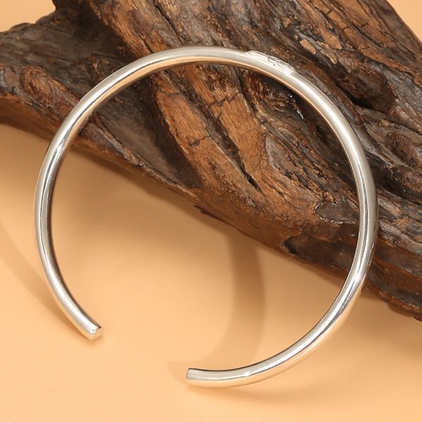 Sterling silver bangle bracelet, oval solid silver centerpiece engraved with a lotus flower