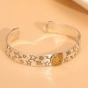 Sterling silver bangle bracelet, three gold-tone happy smile faces engraved on the bracelet.