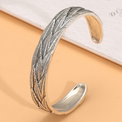 Sterling silver bangle bracelet, bracelet surface engraved with feathers