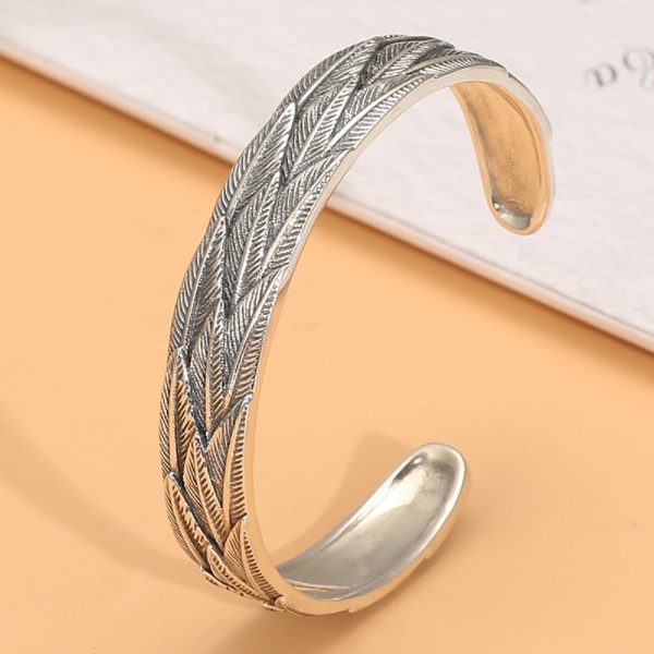 Sterling silver bangle bracelet, bracelet surface engraved with feathers