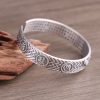 Woven Texture Sterling Silver Open Cuff Bangle, front view, Buddhist symbol and woven texture carving detail