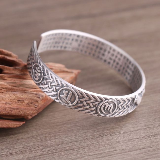 Woven Texture Sterling Silver Open Cuff Bangle, front view, Buddhist symbol and woven texture carving detail