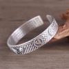 Woven Texture Sterling Silver Open Cuff Bangle, left view, Buddhist symbol carving detail
