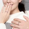 Close-up of personalized engraving on silver infinity promise rings