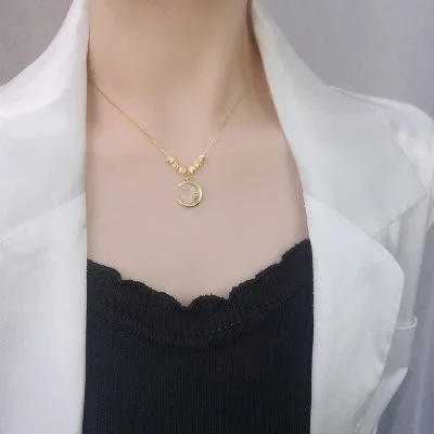 Woman wearing the gold-toned "Lunar Grace" Rabbit Moon Necklace, a stylish Easter gift idea