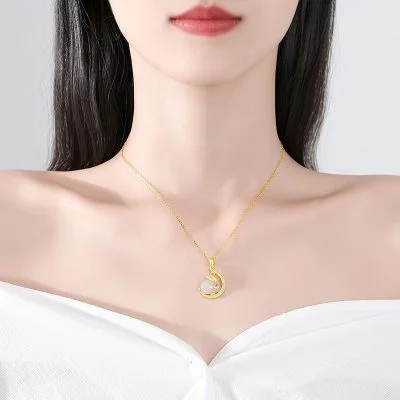 Woman wearing the "Lunar Grace" White Agate Rabbit Moon Pendant in 18K Gold Plated Silver