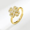 Gold plated sterling silver rings for women featuring a spinning four-leaf clover set with shimmering moissanite stones.