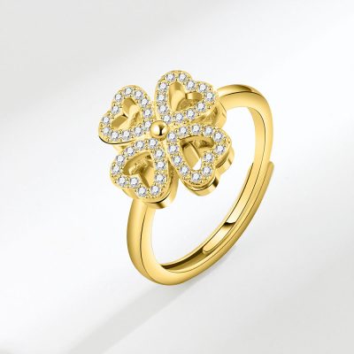 Gold plated sterling silver rings for women featuring a spinning four-leaf clover set with shimmering moissanite stones.
