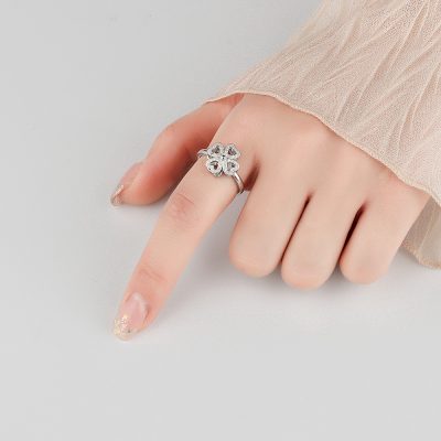 Close-up of a woman wearing the rotatable silver clover ring, showcasing its elegant fit and sparkling moissanite detail.