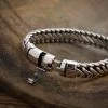 Detailed view of the secure S925 hallmark stamp and safety latch on a men's sterling silver jewelry piece.